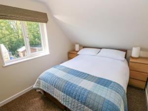 a bedroom with a bed and a window at Mill View in Milford Haven