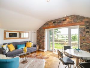 a living room with a couch and a table at Boundary Barn in Bristol