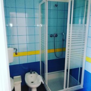 a bathroom with a shower and a sink at Hotel Eira Da Pedra in Vila Nova de Milfontes
