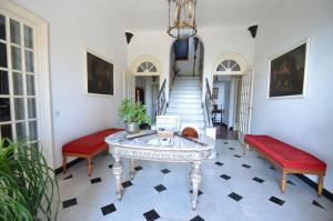 a room with two benches and a table and a staircase at Resort Villa San Luca CITR8031 in Imperia
