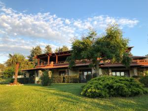 una casa con un patio verde delante de ella en Casa Vacanze Patrizia, en Montefiore dellʼAso