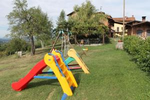 a playground with a slide in a yard at Il Palazzetto in Clavesana