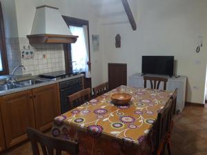 a kitchen with a table with a bowl on it at La Casa di Ida in Porciano +16 photos