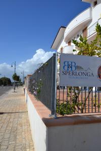 un panneau sur une clôture devant un bâtiment dans l'établissement B&B Sperlonga, à Sperlonga
