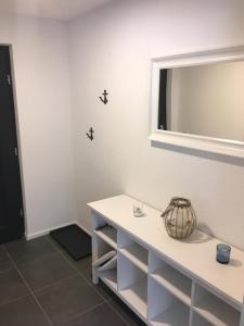 a bathroom with a white counter and a mirror at Fewo Suggental in Buchholz