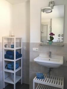 a bathroom with a sink and a mirror at Fewo Suggental in Buchholz