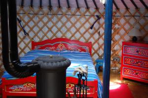 1 dormitorio con 1 cama en una yurta en Maison d'hôtes et Campement Mariposa, en Lanne