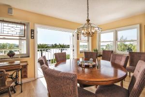 a dining room with a table and chairs at Joyce's Beachfront Penthouse in Clearwater Beach