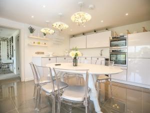 a kitchen with a white table and chairs at Shutts House Garden Apartment in Salisbury