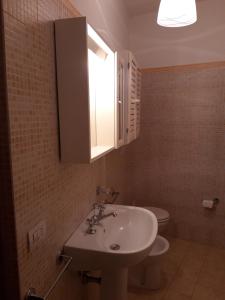 a bathroom with a sink and a toilet at La Casa di Ida in Porciano