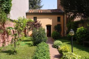 a house with a walkway in front of a yard at Il Giardino Fiorito in Ferrara