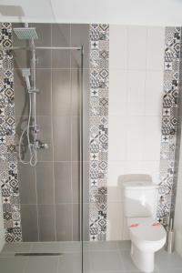 a bathroom with a toilet and a glass shower at Pensiunea Iliada in Sibiu +30 photos