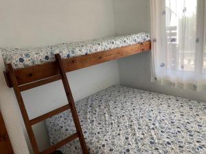 Etagenbett in einem Zimmer mit Fenster in der Unterkunft Senya salvi 12 in Sant Feliu de Guixols