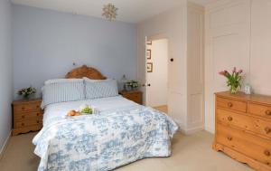 a bedroom with a bed with a tray of fruit on it at Cobbles House in Whitby