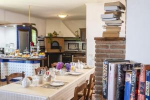 a long table with chairs and books on a wall at Villa Monica B&B in Sorrento