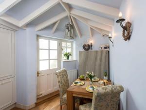 a dining room with a table and chairs at Cobbles House in Whitby