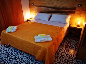 a bedroom with a bed with two towels on it at Trapani Destinations b&b in Trapani