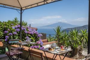 a table and chairs with a view of the ocean at Villa Monica B&B in Sorrento