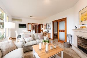 a living room with a couch and a fireplace at LAS HORTENSIAS WITH PRIVATE POOL in Santa Brígida