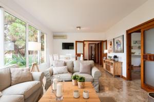 a living room with a couch and a table at LAS HORTENSIAS WITH PRIVATE POOL in Santa Brígida