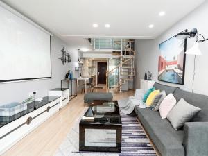 a living room with a couch and a table at Mr. No.1 Apartment in Ningbo