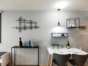 a dining room with a white table and chairs at Mr. No.1 Apartment in Ningbo