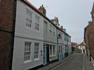 a row of buildings on a street at Fossil Cottage in Whitby