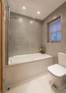 a bathroom with a tub and a toilet and a sink at Gavel Cottage in Whitby