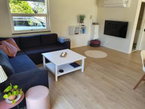 a living room with a couch and a table at Holiday home Als in Nordborg