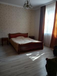 sypialnia z łóżkiem w pokoju z oknem w obiekcie Nino's Holiday Appartment w Bordżomi