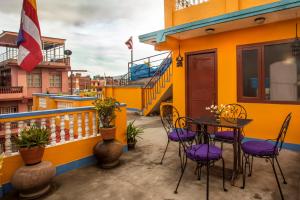 a patio with a table and chairs on a balcony at Peace and Joy Guest House in Pātan