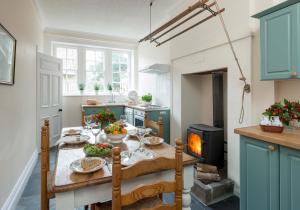 a kitchen with a table with food on it at Manor Cottage in Whitby