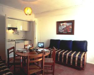 a living room with a table and a couch at Apartamentos Turisticos Regina in Albufeira