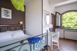 a bedroom with a bed and a desk and a window at Villa Monica B&B in Sorrento