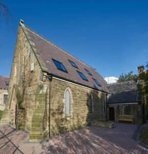 an old brick church with skylights on it at Preacher's Rest in Grosmont