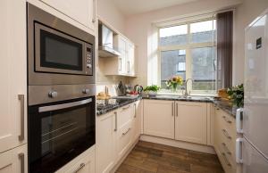 a kitchen with a microwave oven and a sink at Limber View in Grosmont