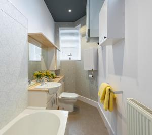 a bathroom with a toilet and a sink at Mews Cottage in Whitby