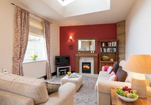 a living room with a couch and a fireplace at Mews Cottage in Whitby