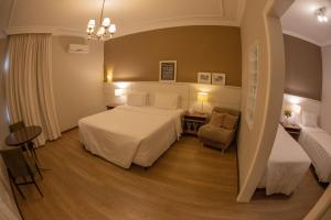 מיטה או מיטות בחדר ב-Planalto Select Hotel Ponta Grossa