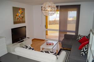 a living room with a couch and a television at Porto Santo Blue House in Porto Santo