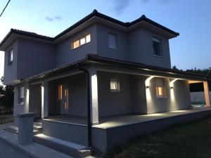 a house with lights on the front of it at Villa Elezovic in Čapljina