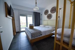A bed or beds in a room at Lamda Deluxe Apartments
