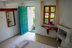uma sala de estar com uma porta azul e uma lareira em myndos bed & breakfast em Bodrum City