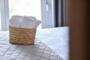 A bed or beds in a room at Lamda Deluxe Apartments