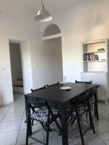 a black table and chairs in a room at A casa di nonna Lina in Polignano a Mare