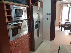 een keuken met een magnetron en een koelkast bij Alojamiento El Olivo in Ronda