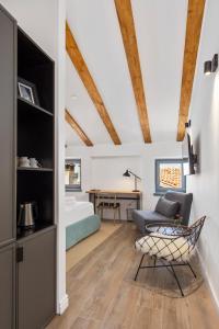 a living room with a bed and a table at Blubini Heritage House in Rovinj