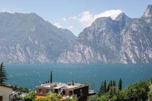 a house with a view of a lake and mountains at SeeLE Garda Hotel in Nago-Torbole