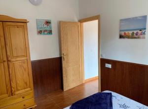 a bedroom with a bed and a wooden door at La Finca de Los Padres in Tefía