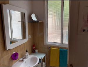 a bathroom with a sink and a mirror and towels at La Finca de Los Padres in Tefía +16 photos